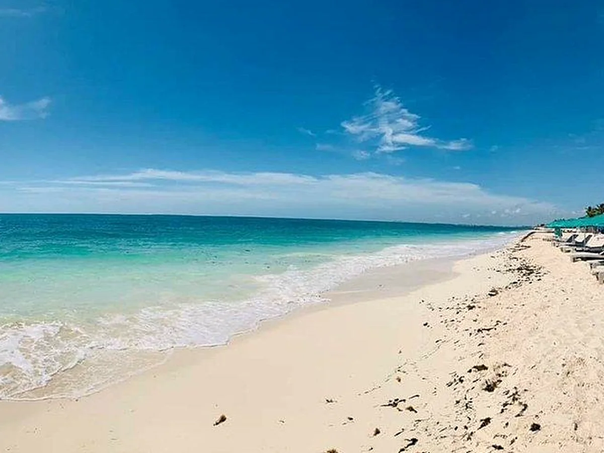 Caribbean surf at Playa Marlín, wide sand in the Hotel Zone
