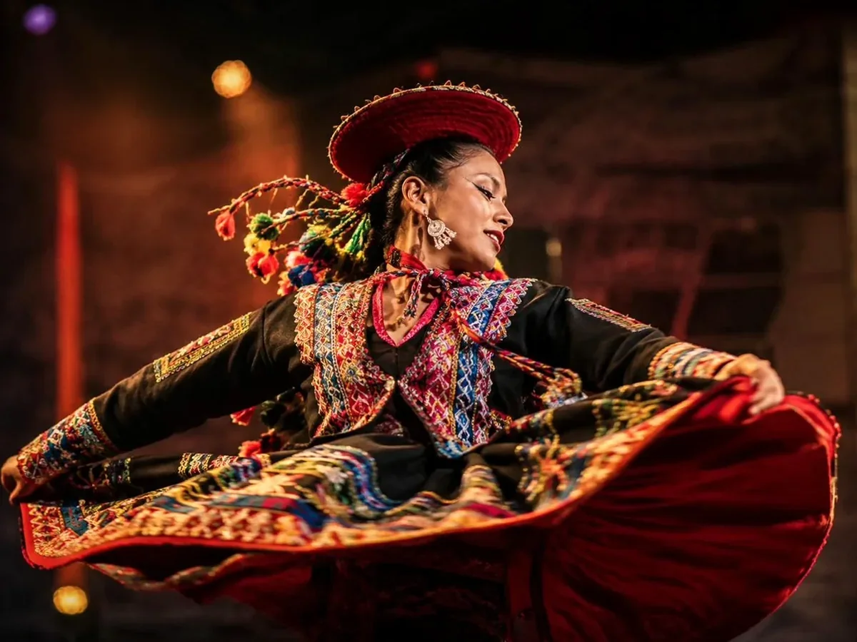 Andean dancers at Tunupa, bright against the darkened room