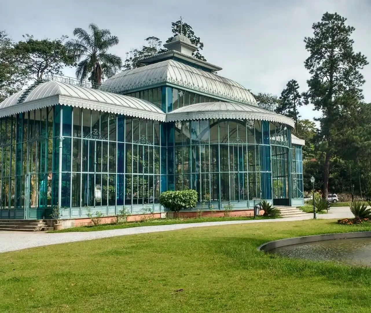 A pavilion of iron and glass, standing open on the lawn
