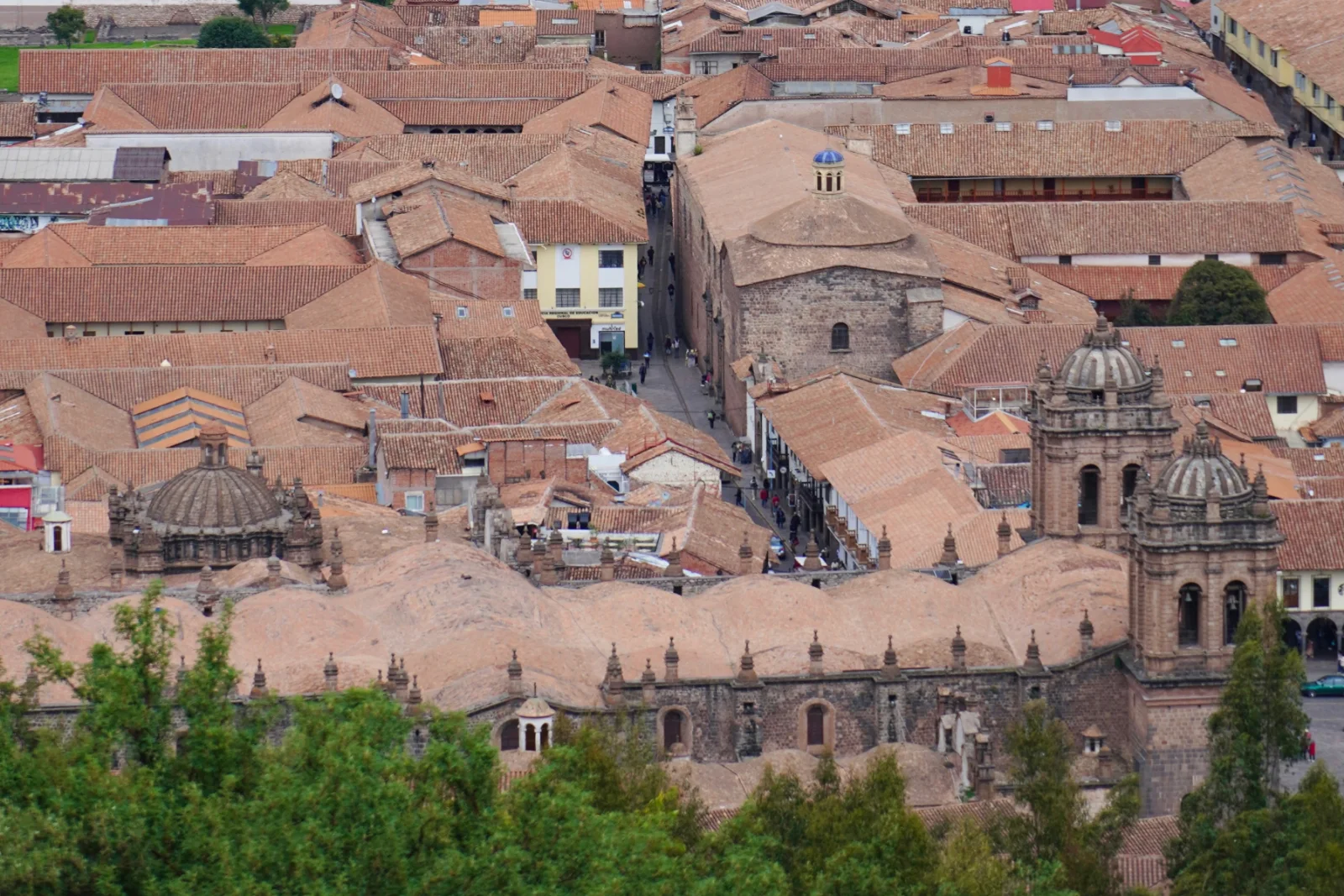The roofs of central Cusco from above, the cathedral towers and domes among tiled colonial roofs