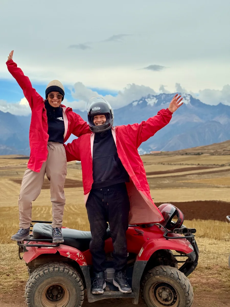 Melissa and Aleksejs with a red quad bike in the Peruvian Andes