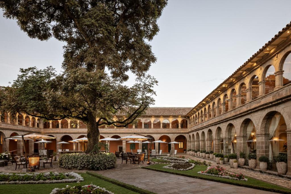 Monasterio, A Belmond Hotel, Cusco — colonial courtyard with a tree at dusk