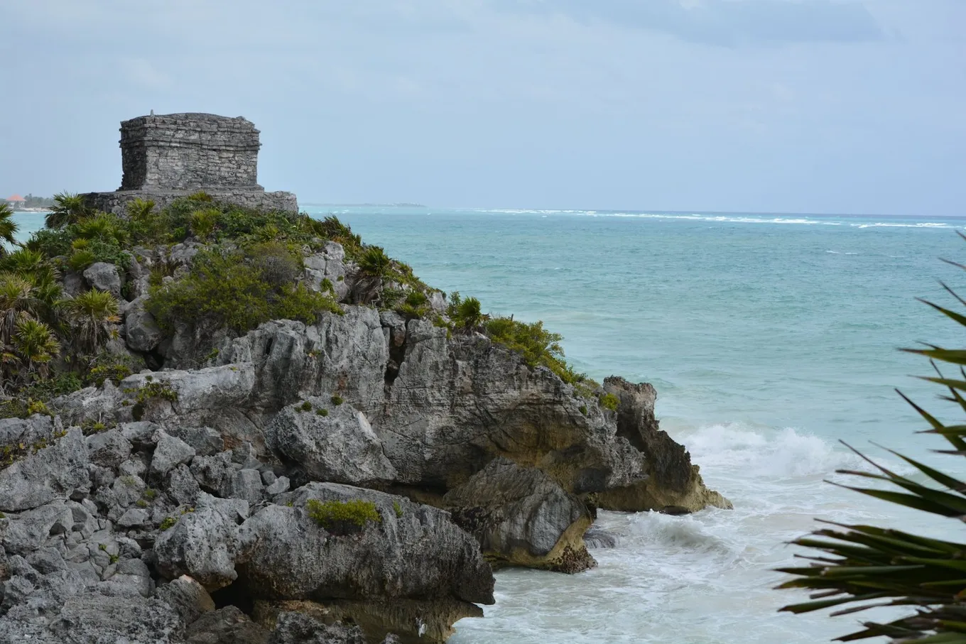 Cloud over the Tulum cliff, the sea gray-green below