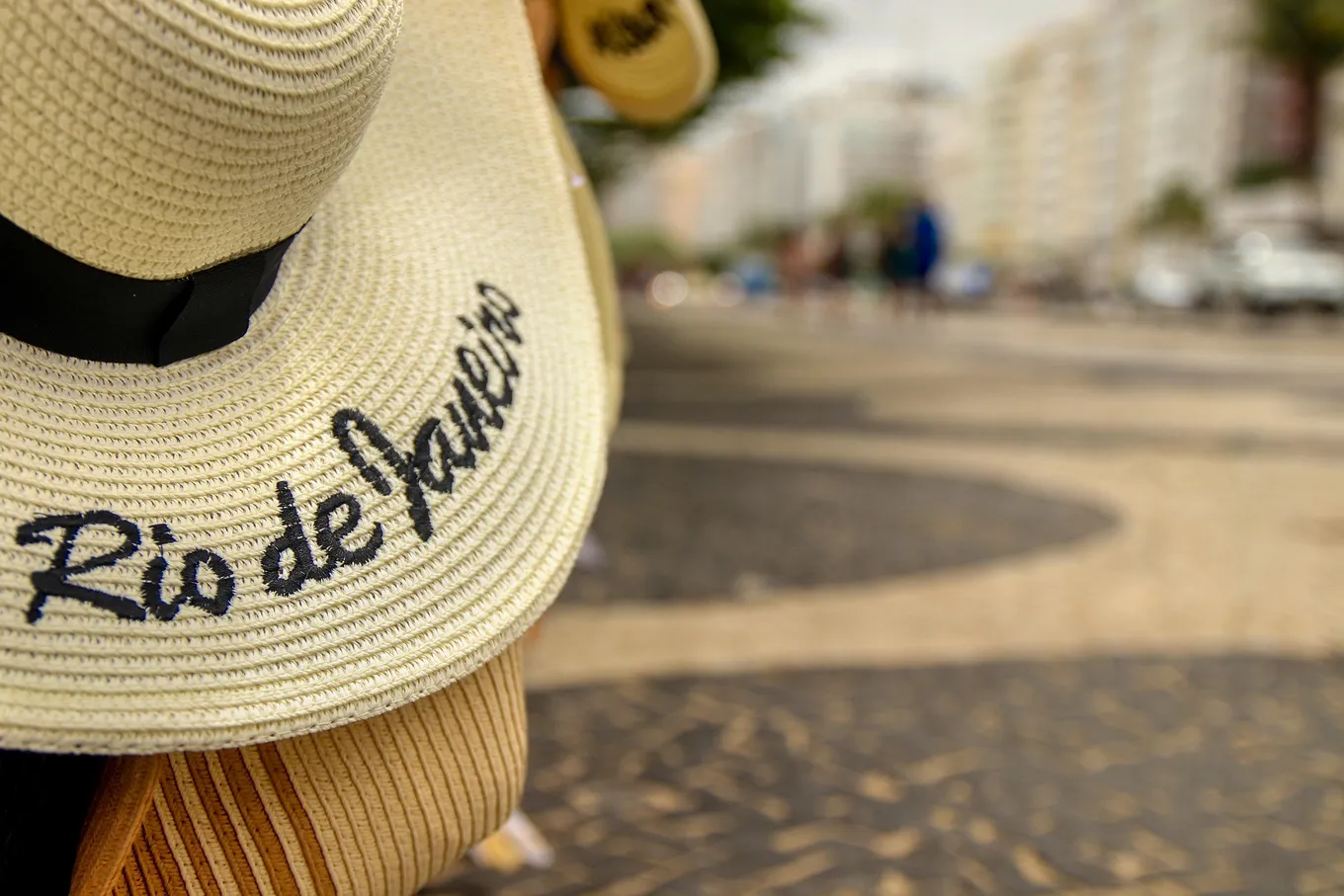 A straw hat stitched with the city's name
