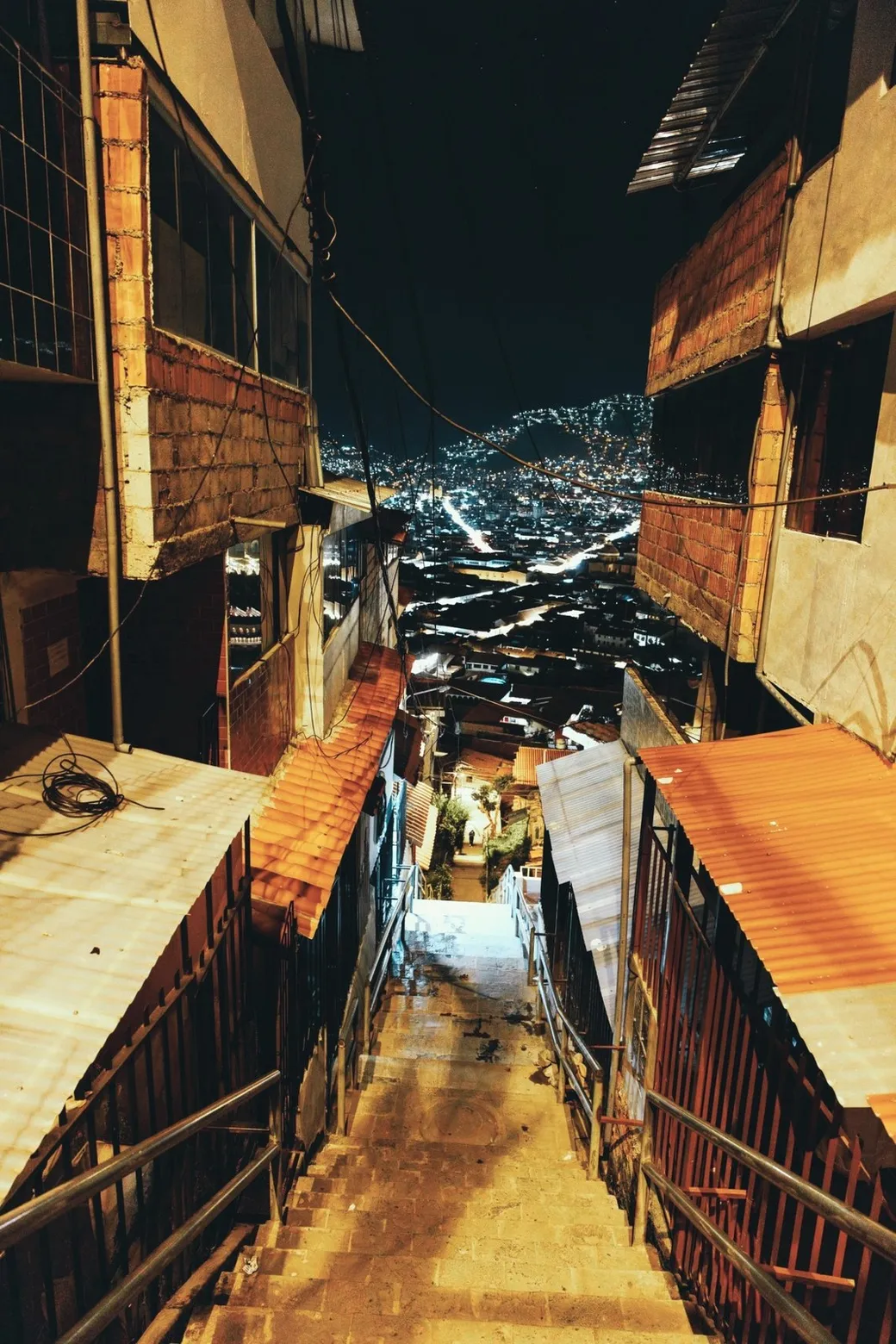 Stairs down to the lights of Cusco, at night