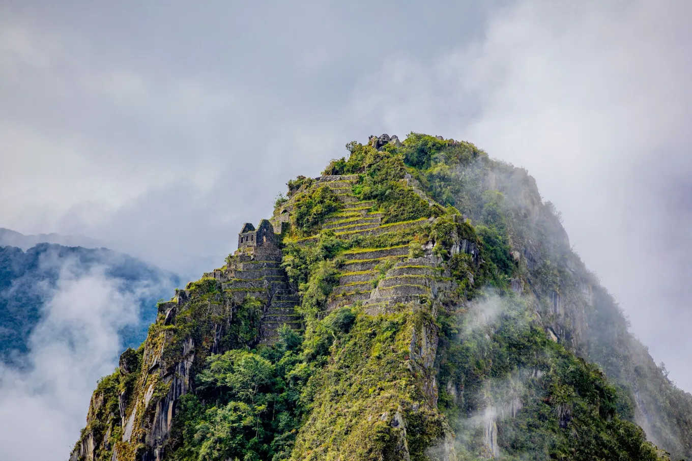 Inca terraces and buildings on the summit of Huayna Picchu, in cloud