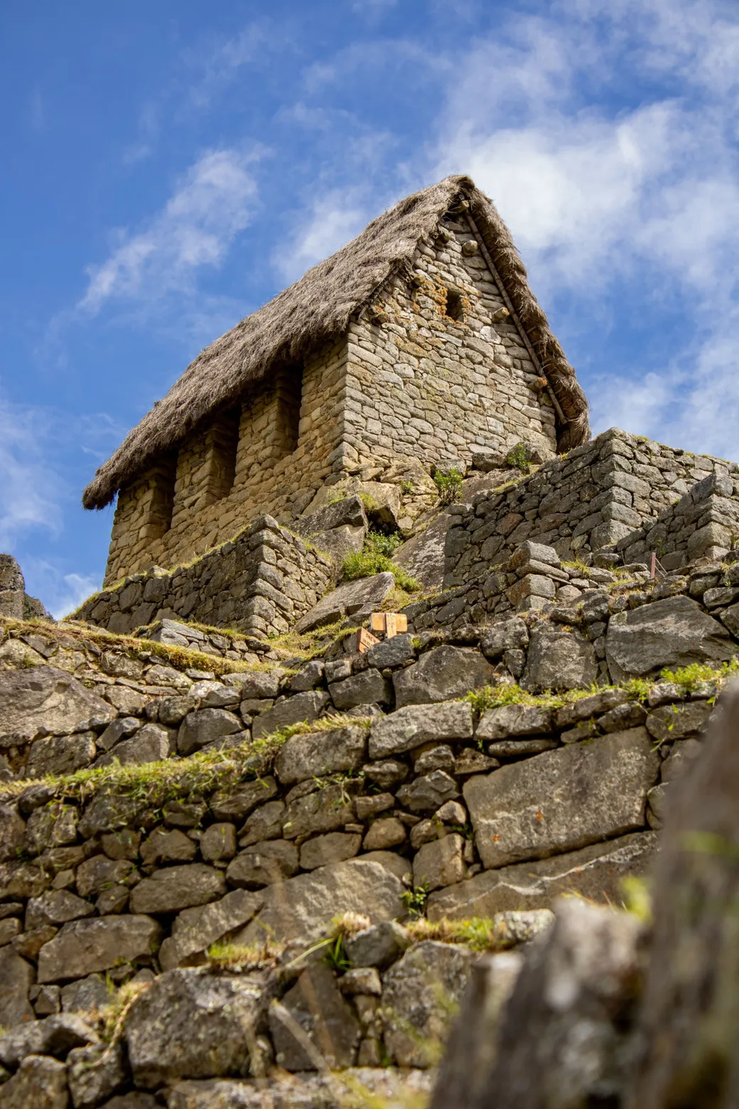 A thatched stone house above the terraces