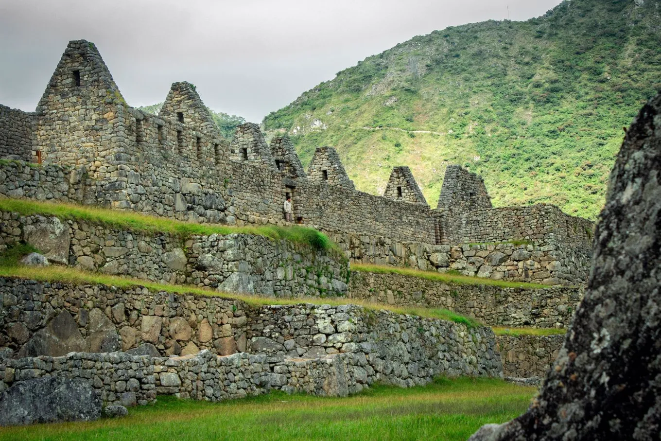 Stone houses with tall gables above the terraces of Machu Picchu