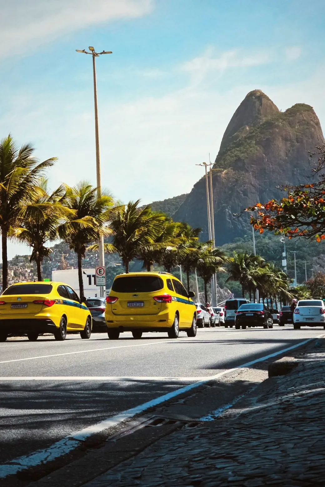 Yellow taxis on an avenue below Dois Irmãos