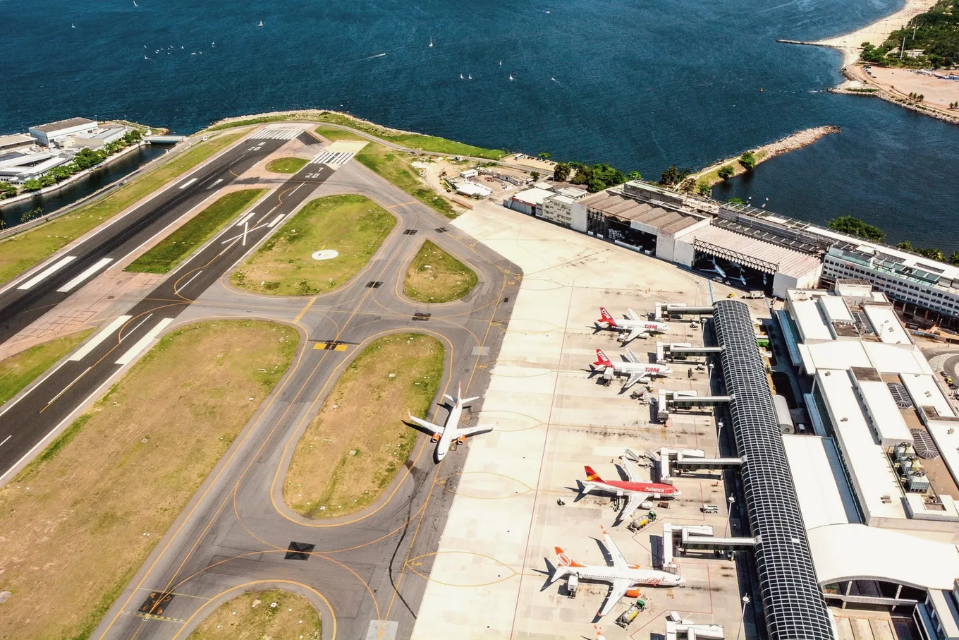 The runway and terminal of Santos Dumont airport from above, beside the bay