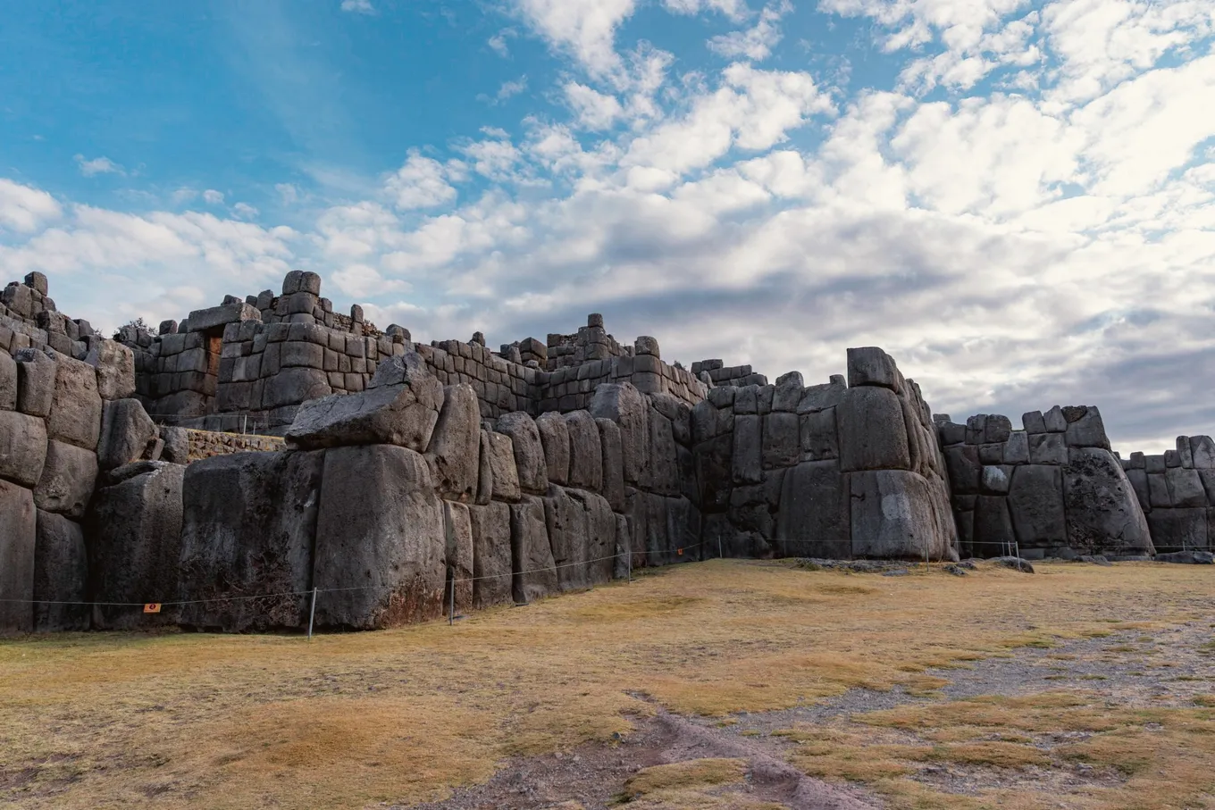 The long stone walls of Sacsayhuamán under a wide sky