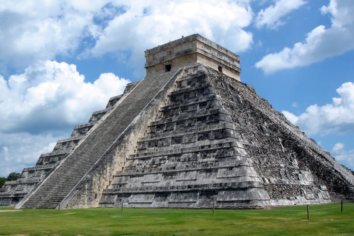 The stepped pyramid of El Castillo at Chichén Itzá under a sky of white clouds