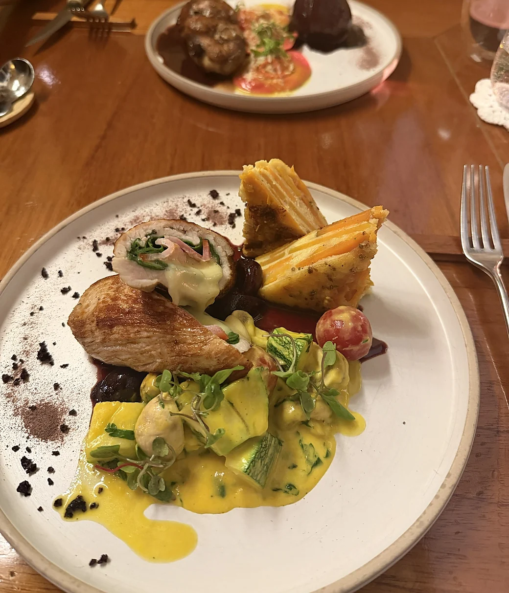 Dinner in Cusco, a glazed pear on the plate across