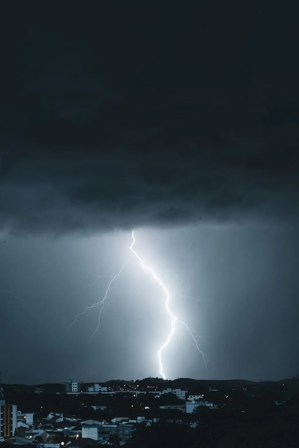 A bolt of lightning over the city at night