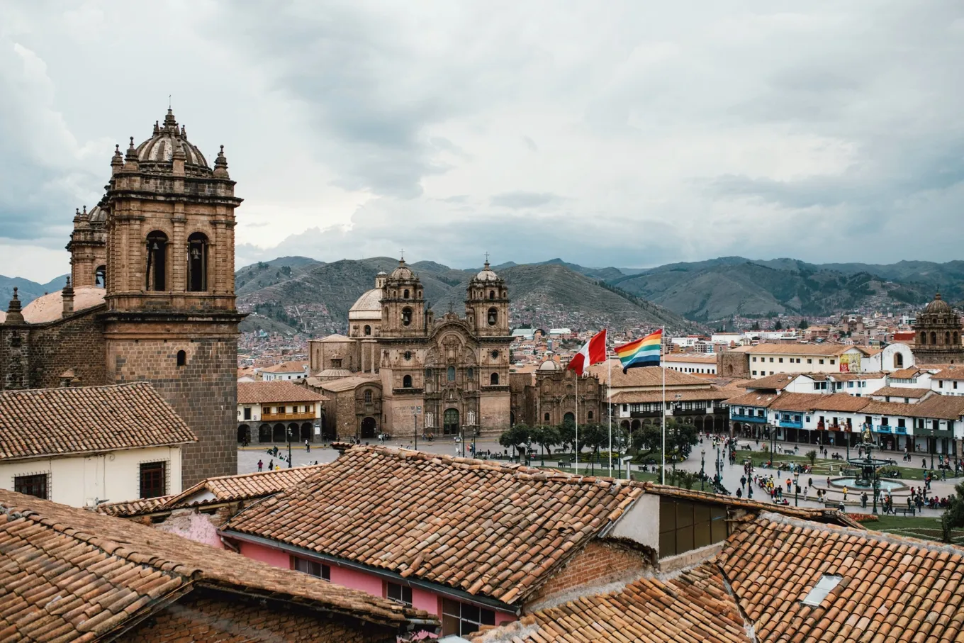 Tiled roofs in the foreground, with church towers and the Plaza de Armas beyond