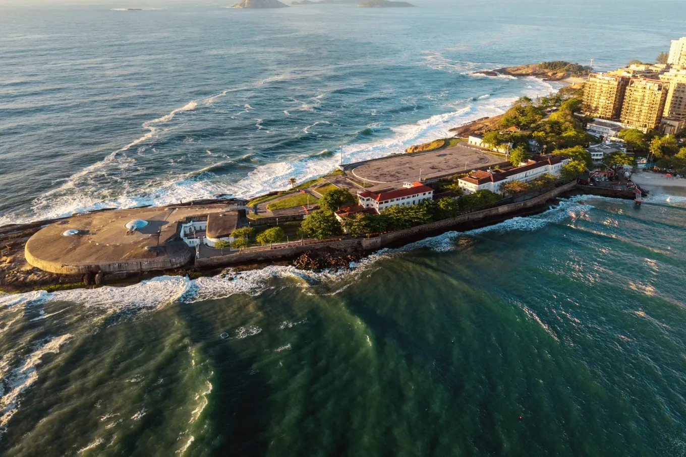 The Copacabana Fort from above on its rocky point, with the sea on three sides and the apartment blocks of Copacabana behind