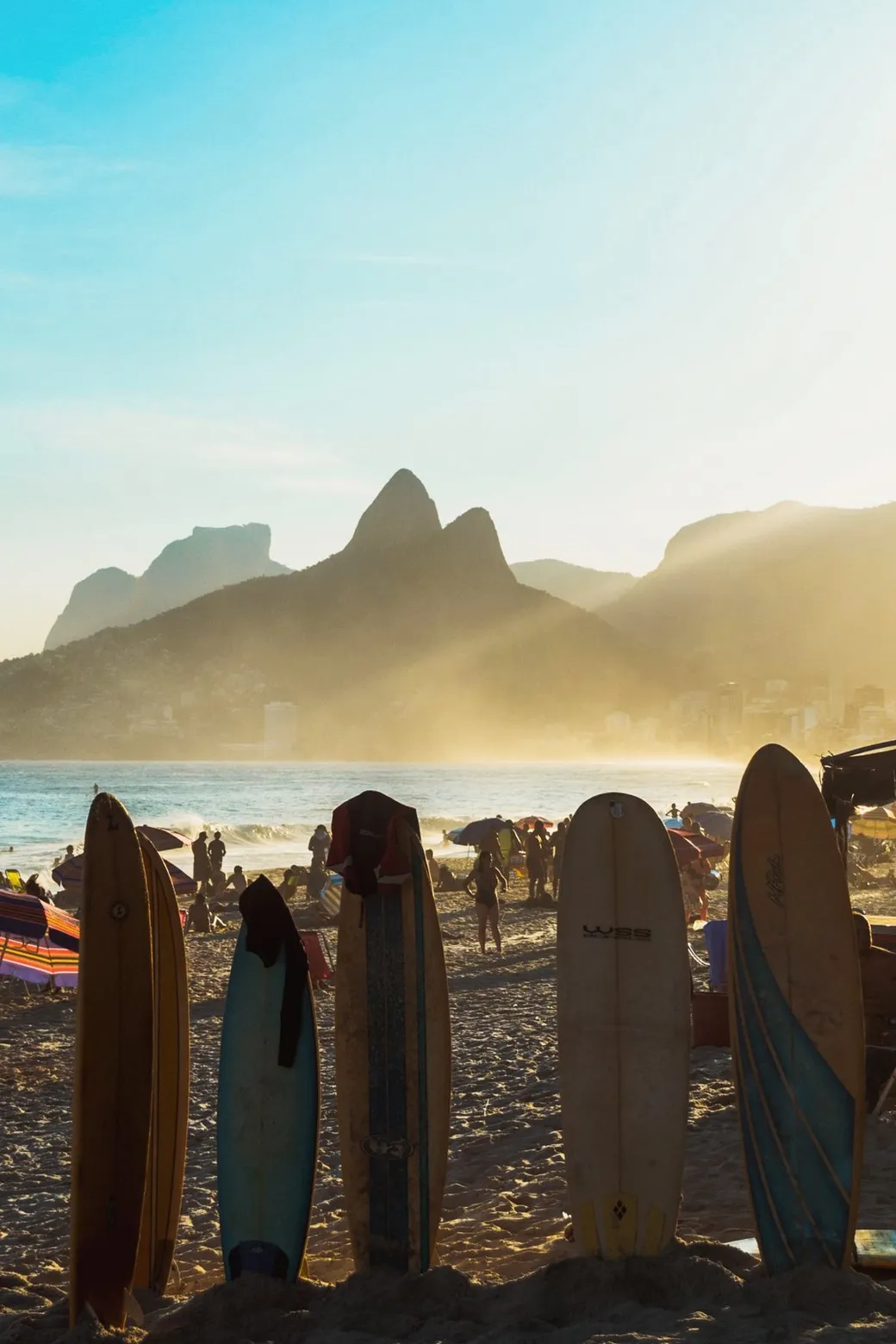 Surfboards on the sand, Dois Irmãos in the haze behind